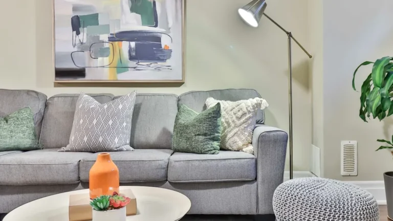 a living room filled with furniture and a painting on the wall