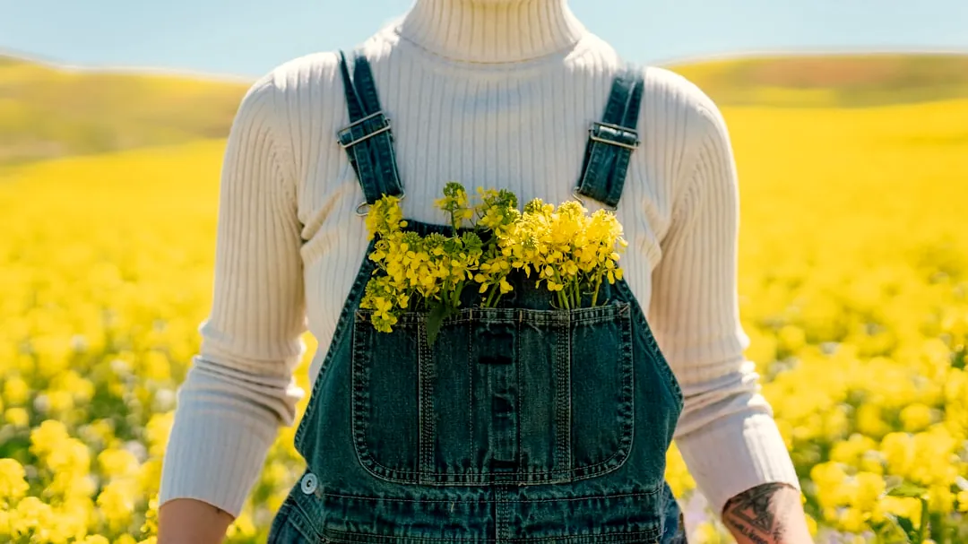 a woman standing in a field of yellow flowers