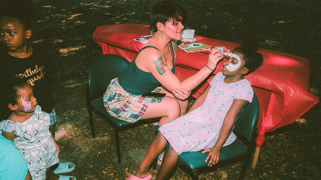 a woman sitting at a table with a plate of food
