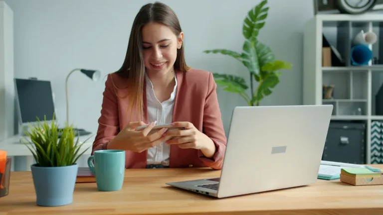 Young woman working at a desk with laptop and laptop