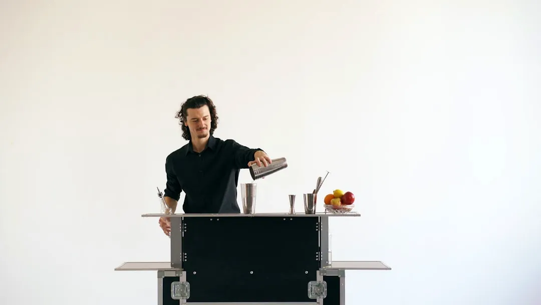 A bartender pouring a drink behind a bar
