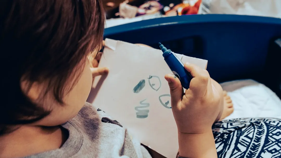 a child drawing on a white paper