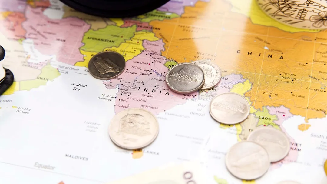 a bunch of coins sitting on top of a map